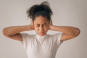 stressed black girl covering ears